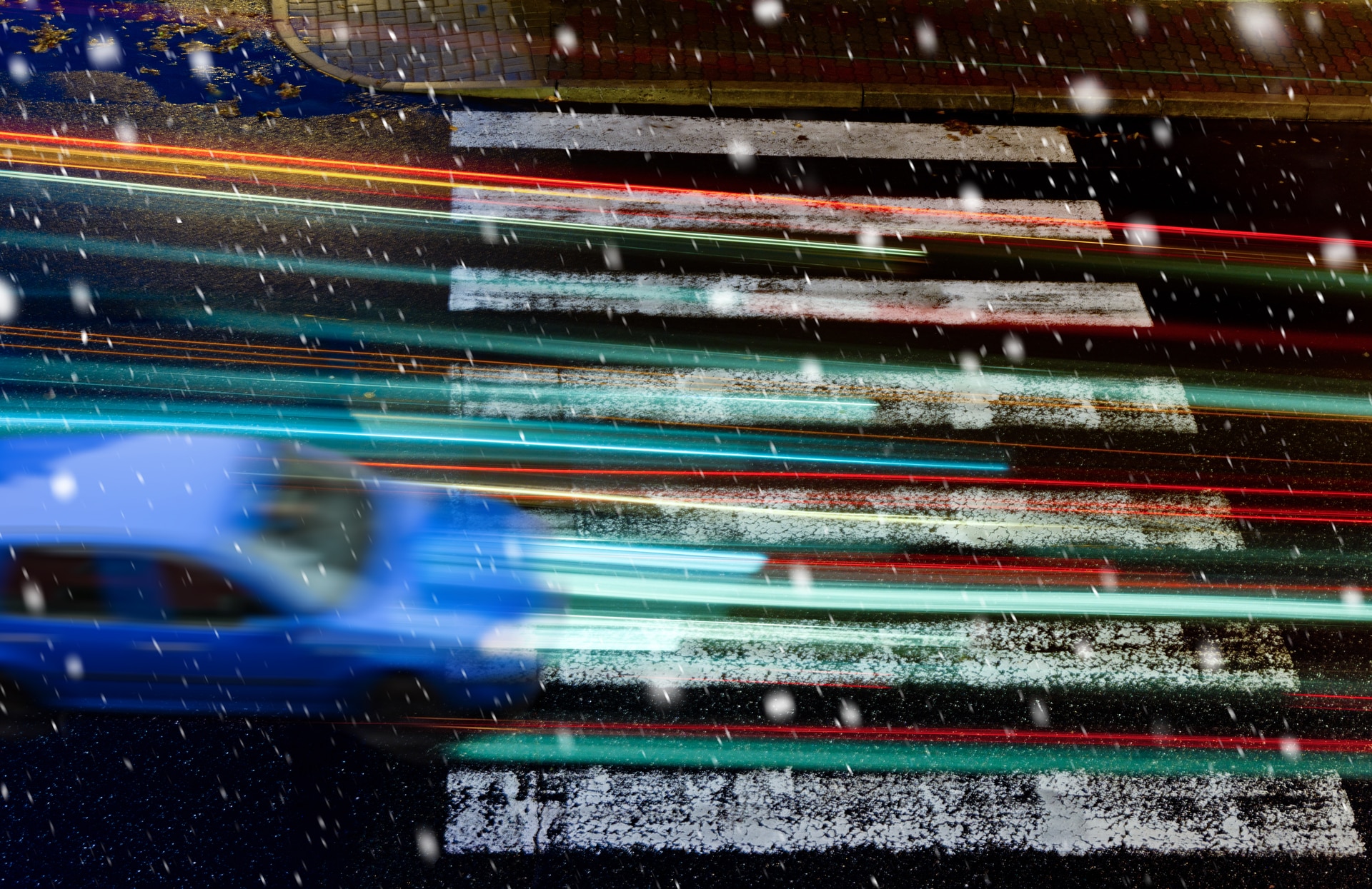 blue car on the pedestrian crossing in the snowfall. Colourbox.com